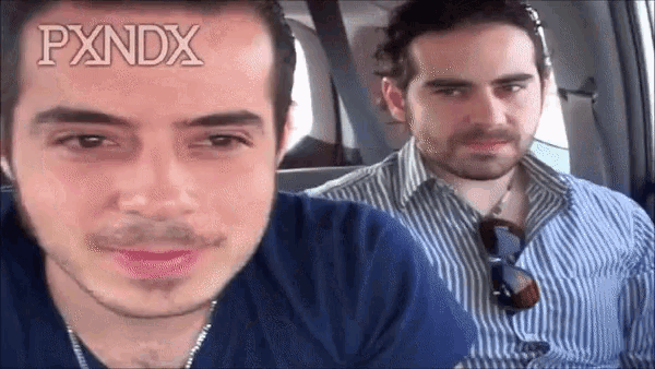 two men in a car with the word pxndx on their face