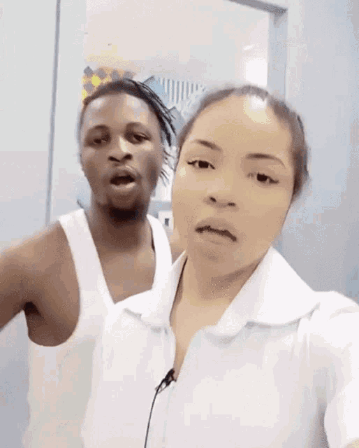 a man and a woman are posing for a selfie