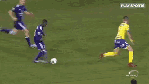 a man in a yellow jersey with the number 2 on it is kneeling on a soccer field