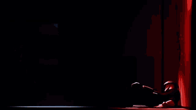 a man holding a briefcase is standing next to a man laying on the ground