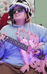 a person wearing a hat and sunglasses is holding a guitar