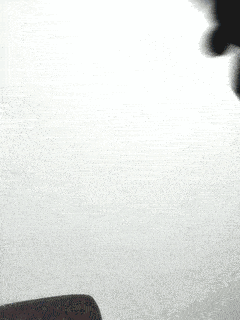 a blue object is flying through the air in a blurry photo