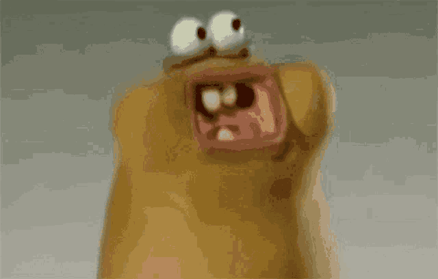 a close up of a cartoon character with big eyes and a mouth open