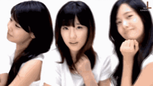 three girls are standing next to each other and the letters l are on the bottom right