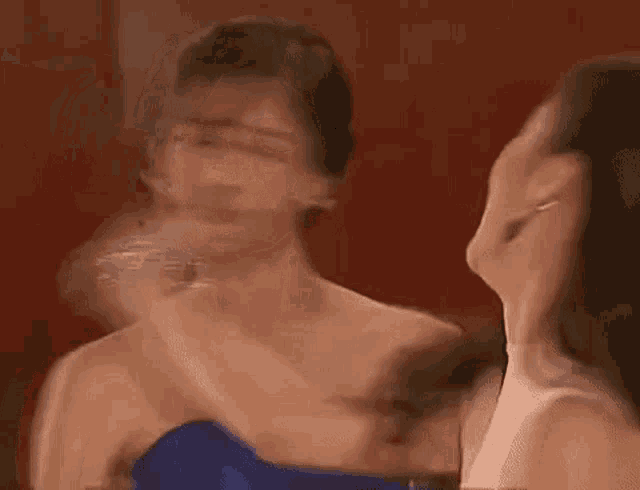 a couple of women are standing next to each other in a room .