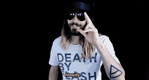 a man wearing sunglasses and a death by flash shirt