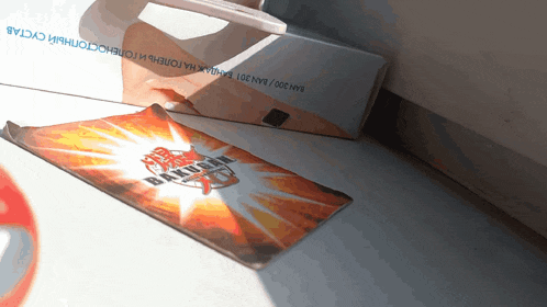 a bakugan card is laying on a table