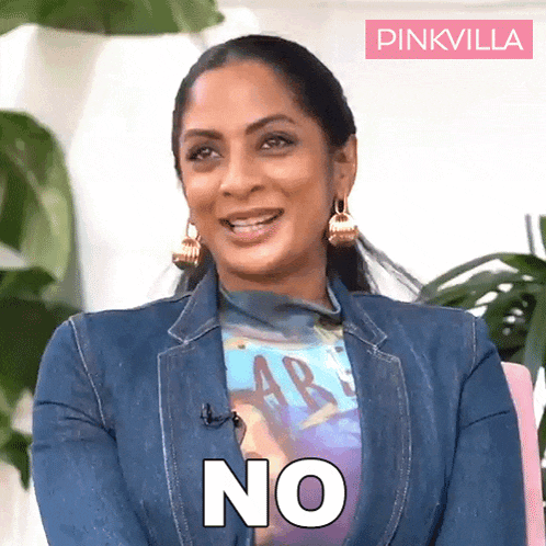 a woman wearing a denim jacket and a t-shirt with the word no on it