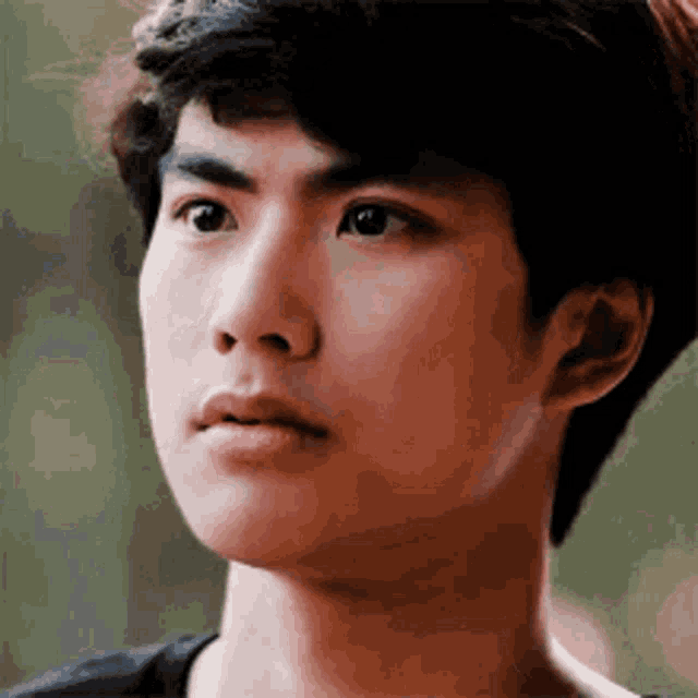 a close up of a young man 's face with his eyes closed .