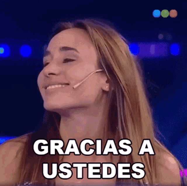 a woman says gracias a ustedes while smiling