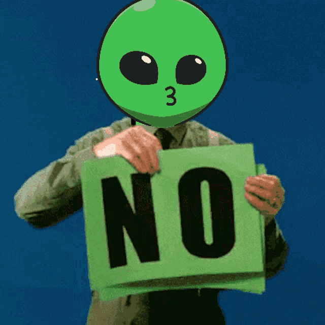 a green alien is holding up a green sign that says no