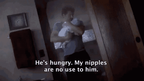 a man is holding a baby and says he 's hungry