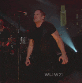 a man singing into a microphone with wliw21 written on the bottom right