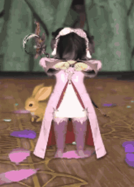 a girl in a pink dress is standing next to a rabbit .