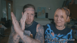 a man and a woman are giving the middle finger with a gif run.com watermark