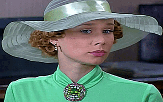 a woman wearing a hat and a green shirt
