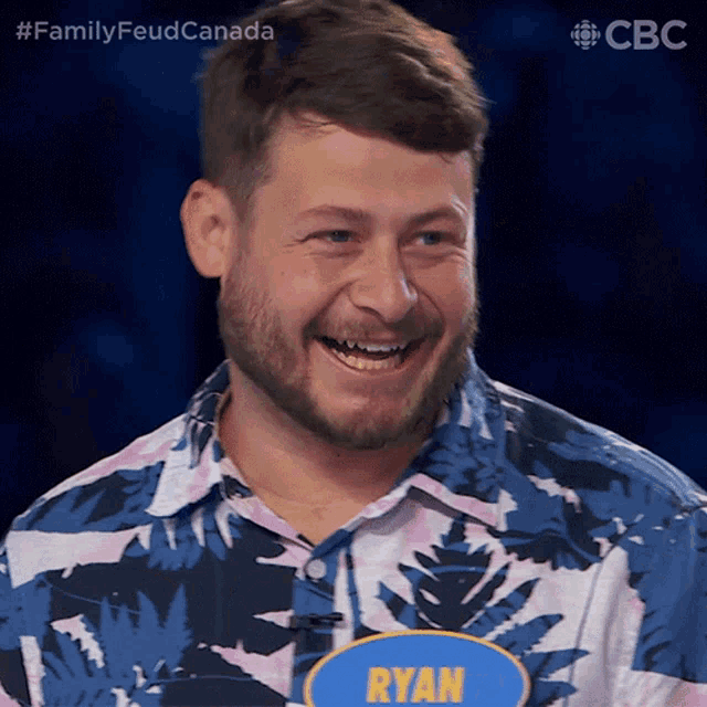 a man with a name tag that says ryan smiles