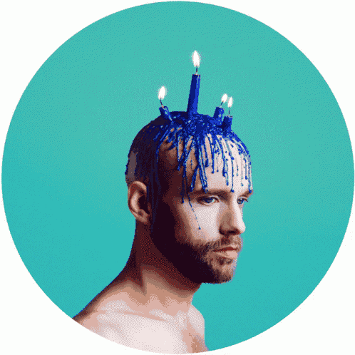 a man with blue candles on his head and a blue background