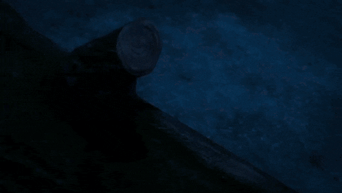 a wheelbarrow is sitting on the side of a road at night