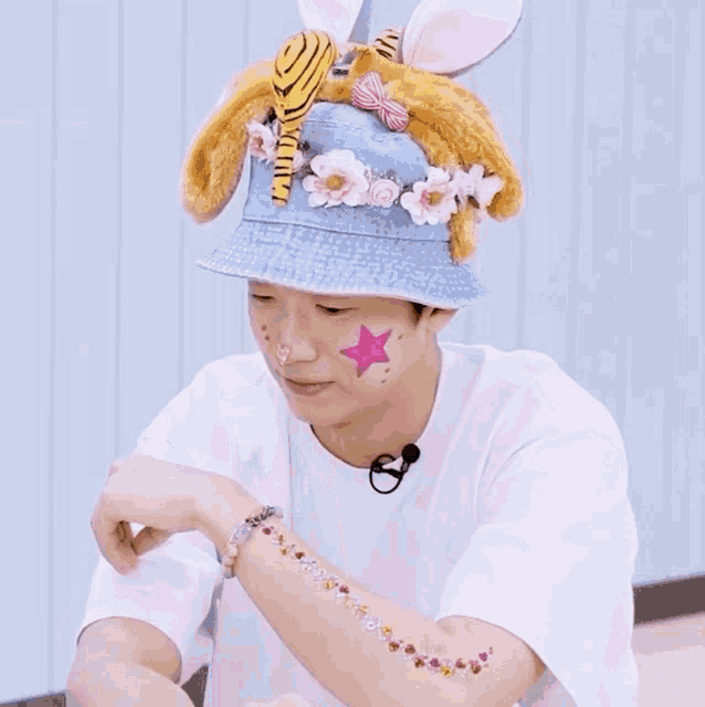 a man wearing a hat with bunny ears and a star on his face