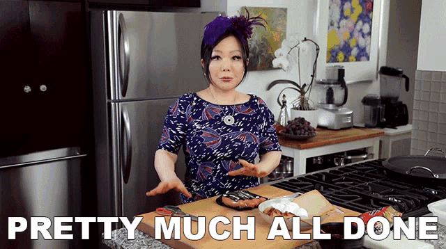 a woman in a kitchen with the words pretty much all done