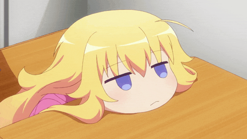 a girl with blonde hair and blue eyes laying on a table