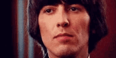 a close up of a man 's face with a serious look on his face and a red background .