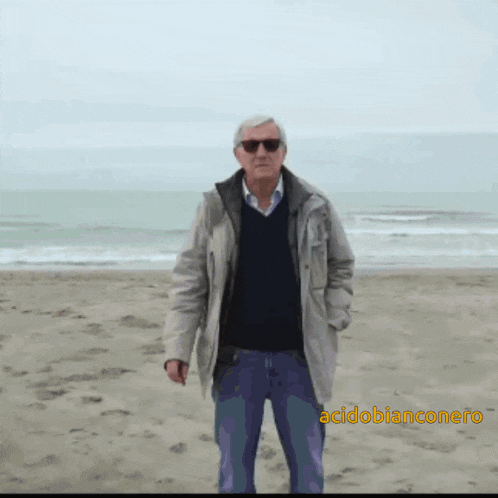a man standing on a beach with the words acidobianconero written below him