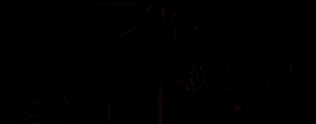 a blurred image of a window with a row of letters hanging from it