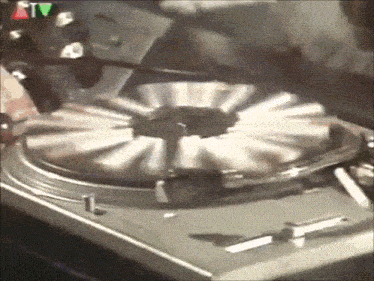 a close up of a record player with a tv logo in the background