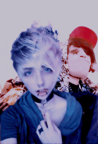 a person with a choker around their neck is standing next to another person with a red hat