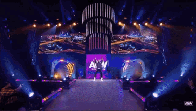 a man stands on a stage with a sign that says all n