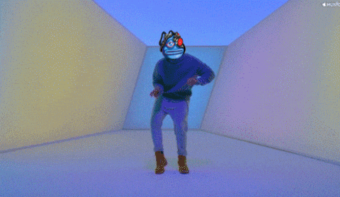 a person with a mask on their head is dancing in a room with a music icon in the corner