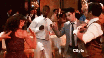 a group of people are dancing on a dance floor at a party .
