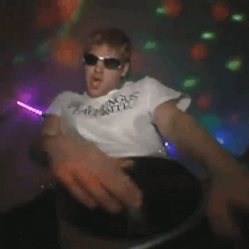 a man wearing sunglasses and a white shirt that says texas boys