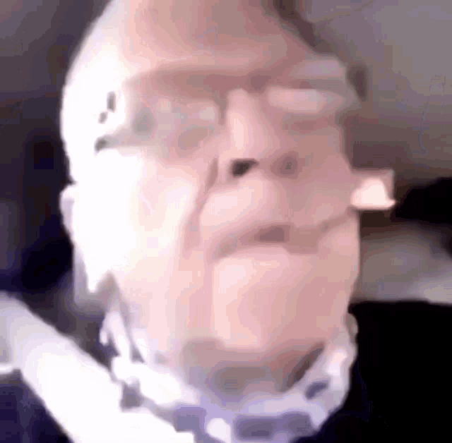 a close up of a man 's face with glasses and a bandage around his neck .