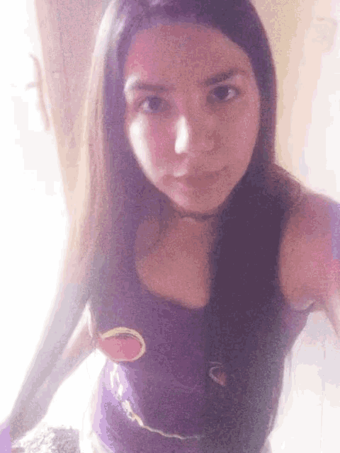 a woman taking a selfie with a purple tank top that says ' strawberry ' on it