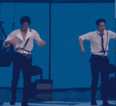 a couple of men are dancing on a stage
