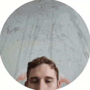 a young man is sitting in front of a wall with a flamingo on it .