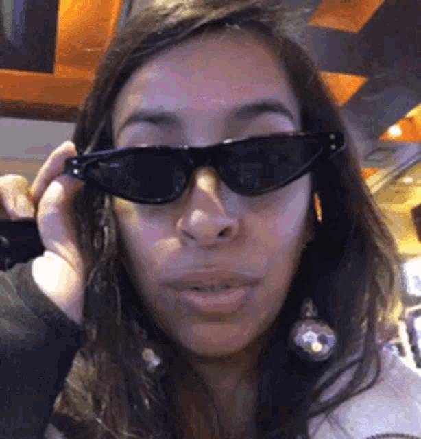 a close up of a woman wearing sunglasses