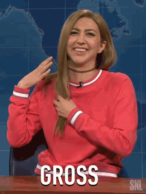 a woman wearing a red sweater with the word gross on the front