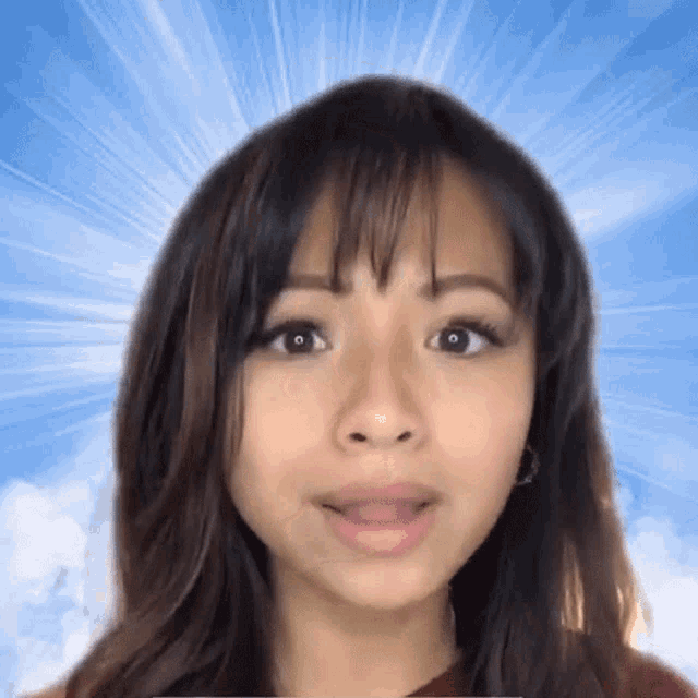 a close up of a woman 's face with a blue sky behind her