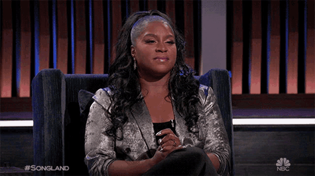 a woman sitting in a chair with a nbc logo in the corner