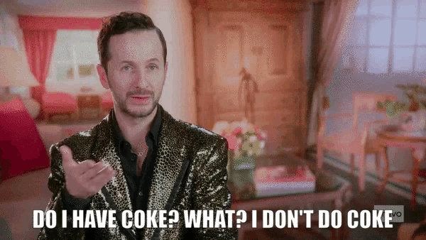 a man in a sequined suit says " do i have coke what i don 't do coke "