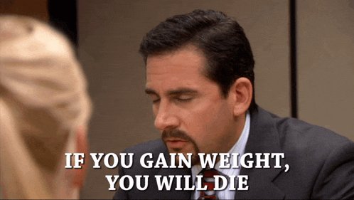 a man in a suit and tie is talking to a woman and says if you gain weight you will die