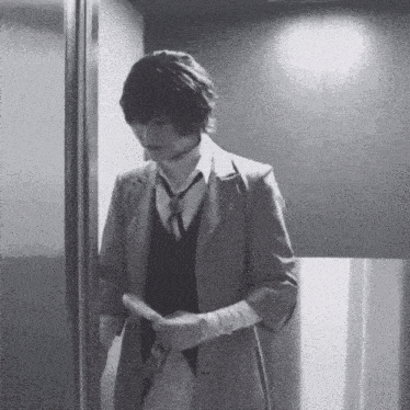 a black and white photo of a man in a suit