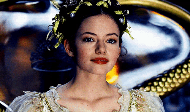 a close up of a woman wearing a crown on her head