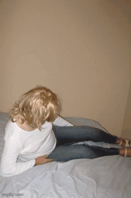 a picture of a woman kneeling on a bed with the url imgflip.com
