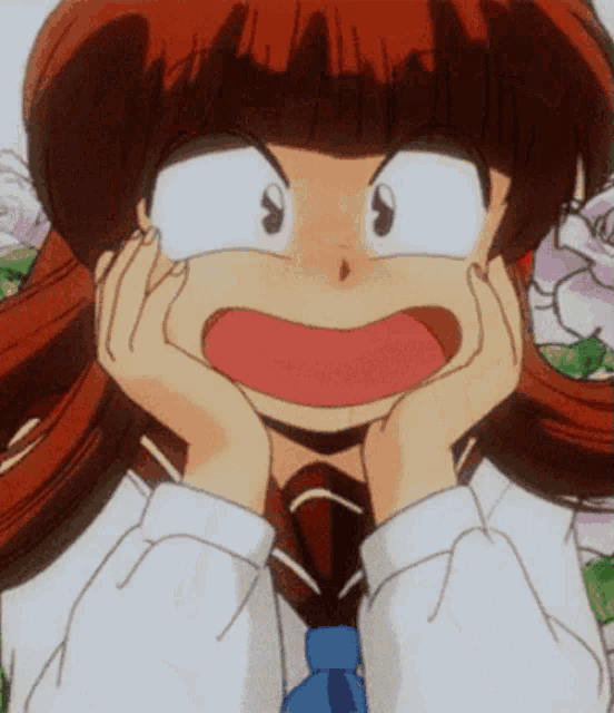 a girl with red hair is making a face with her hands on her face