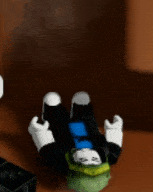 a person is laying on their back in a room with a green shirt on .